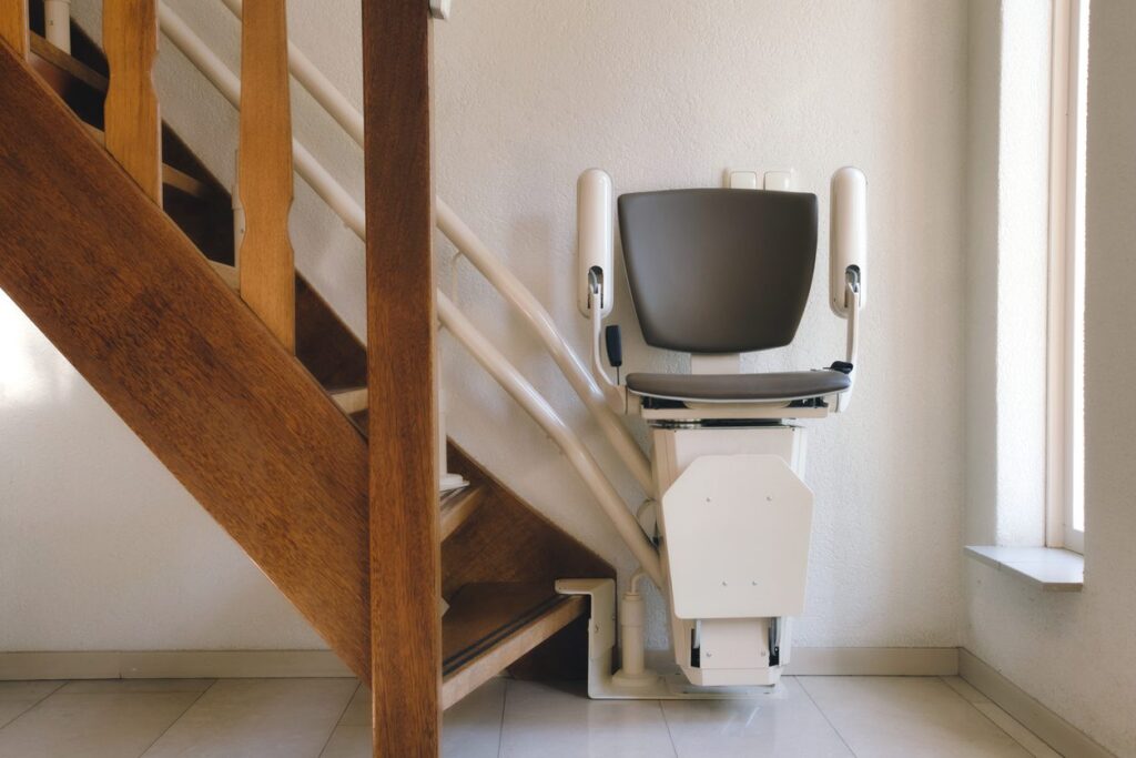 Straight vs Curved Stairlift Removal: What’s the Difference? | Money4Stairlifts Automatic stairlift on staircase for elderly or disability in a house,